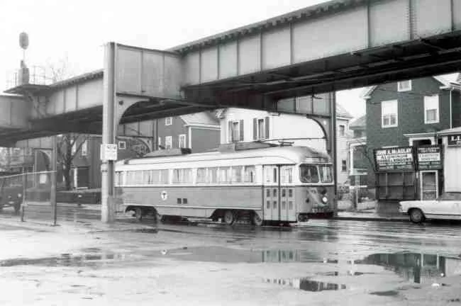 Trolley # 3327 travels up Washington Street on its way into the Arborway yard in this 1969 photo. McAulay Aluminum Doors and Windows storefront can be seen in the first floor of a converted house.