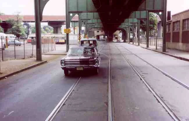 Washington Street near the Arborway MBTA yard seems almost deserted in this 1969 photo. The nice looking Ford Sedan with the number plate 55656 is being followed by a Boston Gas Company service van. 