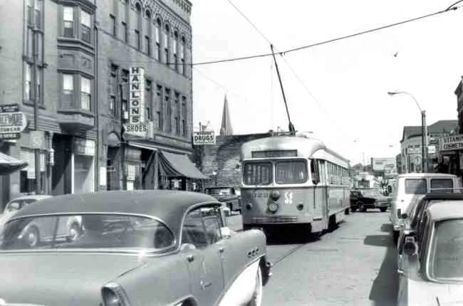 Trolley # 3322 winds its way up a very busy Centre Street during this 1970 photo on its way to Park Street Station. Rogers Drugs can be seen on the corner of Burroughs Street, along with the sign for Hanlon's Shoes which was located up a steep stairway to the second level of the Burroughs building. 
