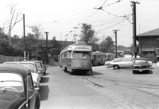 Trolley # 3103 winds its way around the rear of the Arborway yard in this 1960s photo. The vintage cars can be seen along with the view of the Arborway overpass.