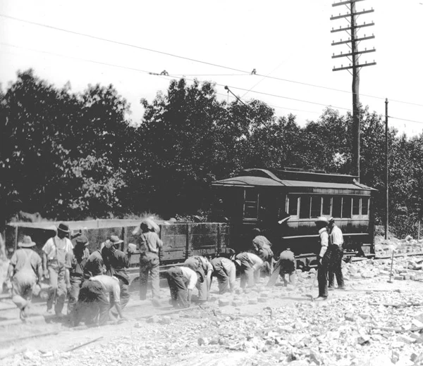 Workers removing paving stones from track bed during maintenance work in West Roxbury ca. 1897. 