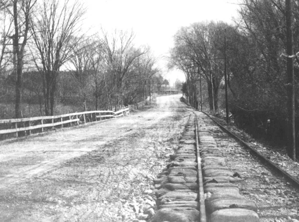 This photograph was labeled "South of Spring Street" and shows sandbags on the line to Needham, probably in Dedham. The sand bags were probably placed there to protect the track bed from flooding.