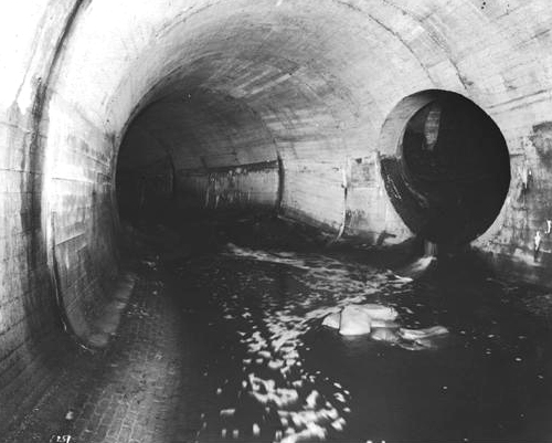   A portion of the system of tunnels that carry the Stony Brook from its origin in the Stonybrook&nbsp; Reservation in West Roxbury to the point where it empties into the Charles River. This undated photograph was taken under Amory Street in Jamaica 