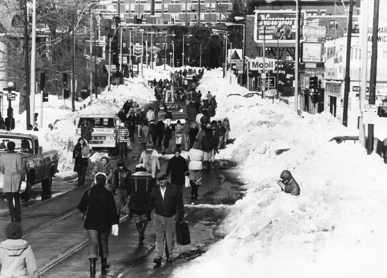 Jamaica Plain residents begin to venture out of their homes after a single lane of traffic is cleared of snow in February, 1978. This view is from Green Steet looking towards Boston. Photograph taken by and provided courtesy of Mark Hoffman.