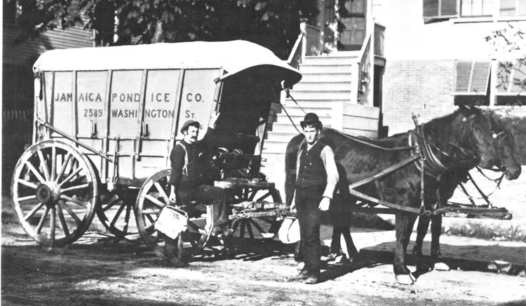 This photograph shows two delivery men using ice tongs to hold blocks of ice cut to the proper size to fit into iceboxes. Photograph courtesy of the Boston Public Library.