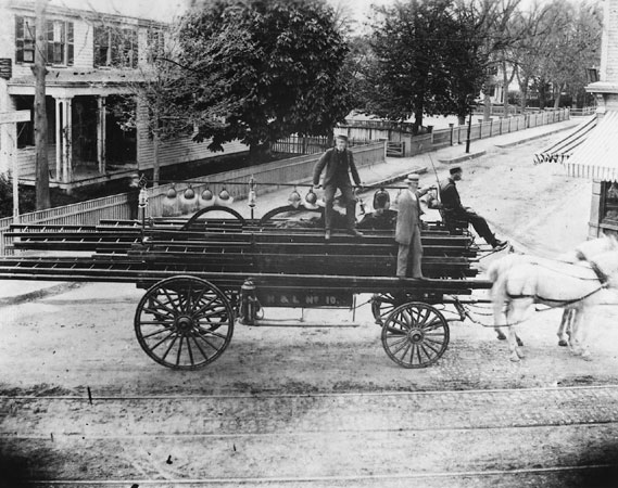 This hook and ladder wagon was photographed in 1885 at the corner of Centre and Burroughs Streets. The Seaverns House is visible to the left.