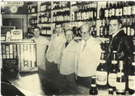  Employees of Patterson’s Liquor Store, from left to right:&nbsp; John Riley, Steve McCauley, Vinnie Boris, Ted Patterson, and John Patterson. Photograph courtesy of the Patterson family. A higher resolution version of this photograph is  available .
