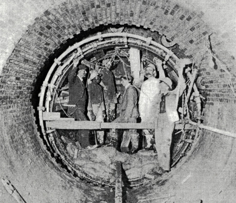  High level sewer, Centre St., Jamaica Plain. Workers are engaged in the construction of a circular tunnel using compressed air tools and a metal shield.&nbsp; From Metropolitan Water and Sewage Board First Annual Report.&nbsp; January 1, 1902.&nbsp;