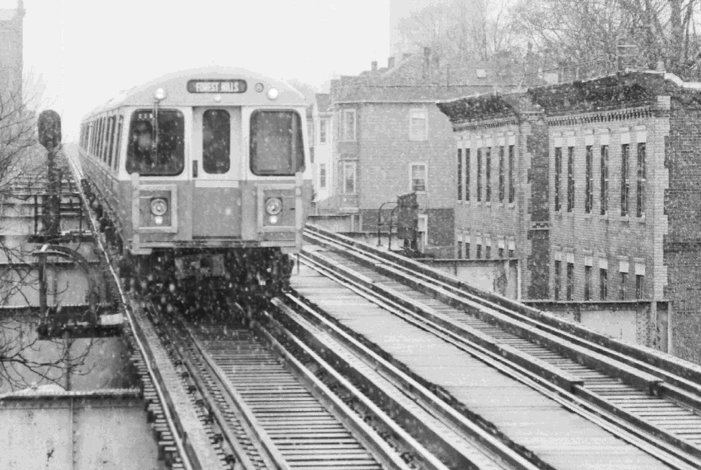 An Orange line trains travels down Washington Street in Jamaica Plain, March 1987. Photograph courtesy of Chris Lovett, Neighborhood Network News.