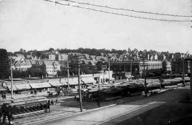 Open trolley cars, used exclusively during the summer months, fill a siding along Washington St. at Forest Hills circa 1900.
