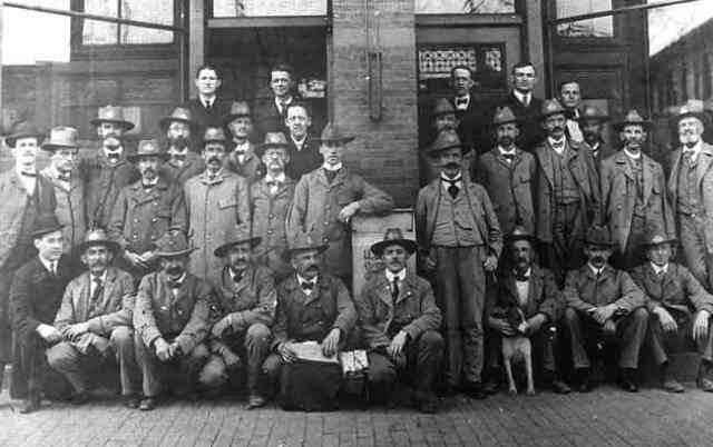 U.S. Postal Service employees pose outside the post office bulding in Woolsey Square near the current location of the Green St. Orange Line station.