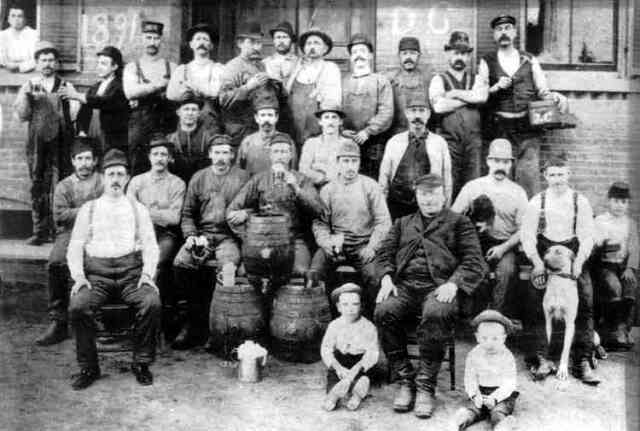 Workers at the Haffenreffer brewery pose outside the plant along with some of their children and a pet in this 1891 photograph. Courtesy of the Boston Public Library.
