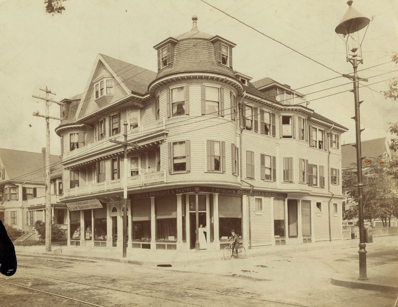   Frederick Morlock (1850-1906), born in Germany and naturalized in 1881, owned the large building at 416 Centre Street and the smaller house next to it at 408 Centre Street. He owned and operated the bakery in the corner store pictured here where El