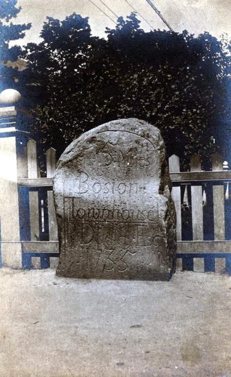 One of five mile markers that remain in the early Roxbury town limits (including West Roxbury and Jamaica Plain until 1851), untouched for the most part by politics, urban redevelopment, and other forms of change and still performing their original function. These milestones show the distance to the Boston Town House (now the Old State House). Pictured here is the five mile marker installed in 1735 and located by the monument at Centre and South Streets in Jamaica Plain. While this marker currently stands closer to the monument, it is shown here as previously located on the opposite side of street from the monument.