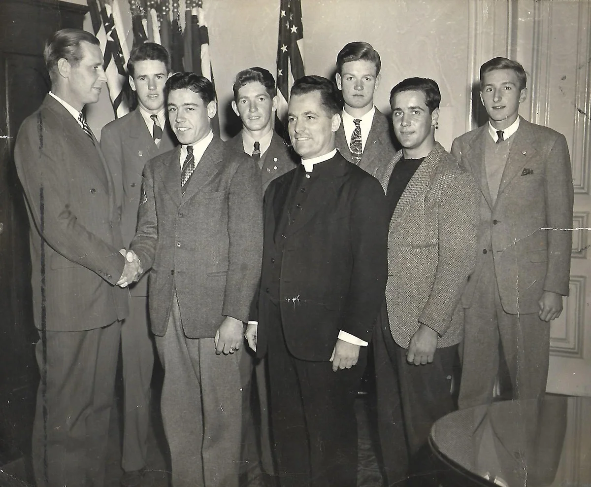 The Most Reverend Joseph F. Maguire is shown in this undated photograph with a group of men of Blessed Sacrament Parish meeting with an unidentified official. Father Maguire was born on Mission Hill, Roxbury, on September 4, 1919. He served in Blessed Sacrament Parish, Jamaica Plain, from 1948 to 1960. In 1977 he became fifth Bishop of Springfield, Mass. He died on November 23, 2014, at the age of 95. Photograph courtesy of Patricia Geary of Braintree, Mass.