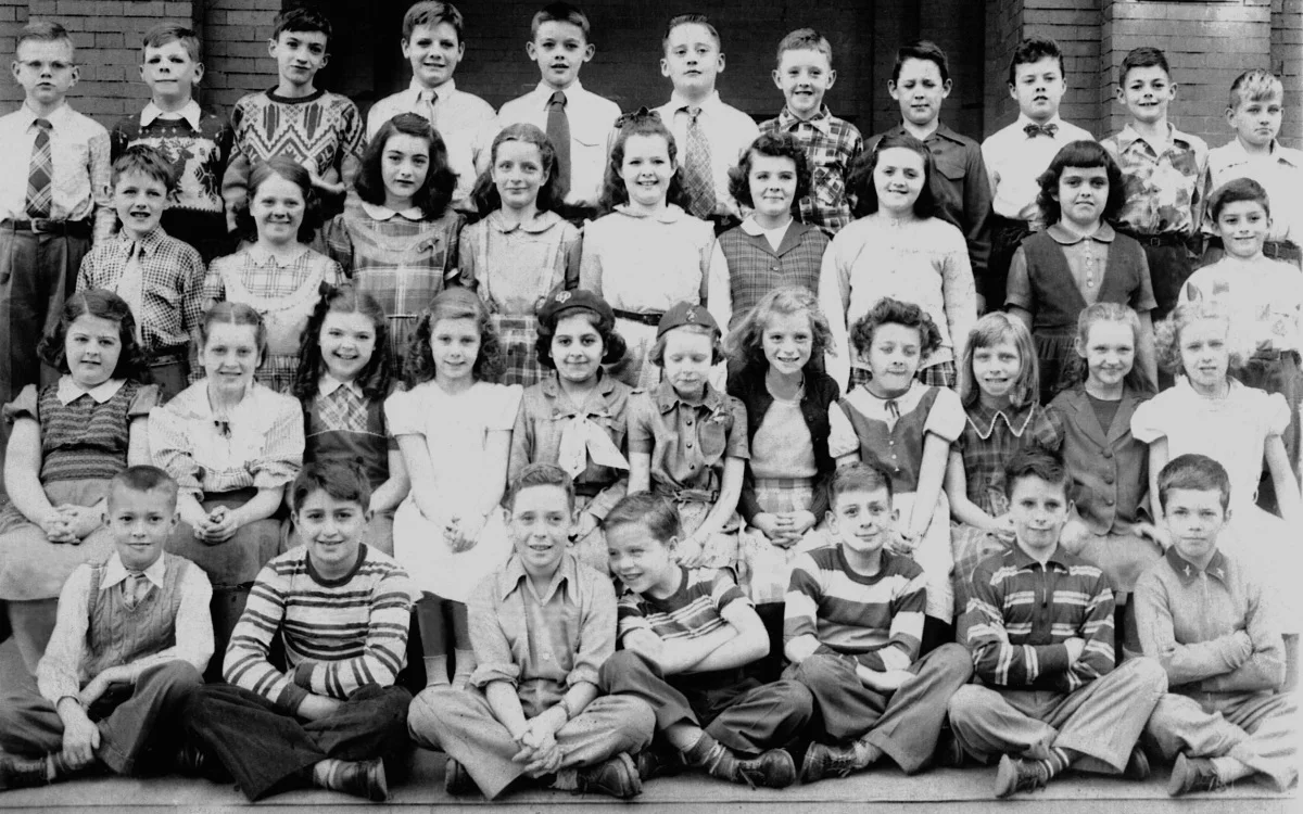 Agassiz School class of Ms. M.C. Moretti. 1951 - 1952. Grade 5. Fourth row : second, sixth, and eleventh from left: Juris Veidens, Richard Bean, and Robert Alquist Third row : sixth and seventh from left: Noreen Kopp and Mae McLean Second row : third, sixth, seventh, and tenth from left: Anne Rock, Jane VanZandt, Nancy Kendall, Marjorie Guerney Front Row : third, sixth, and seventh from left: Michael Steele, Thomas Grady, and Arthur Tilley Courtesy of Art Tilley