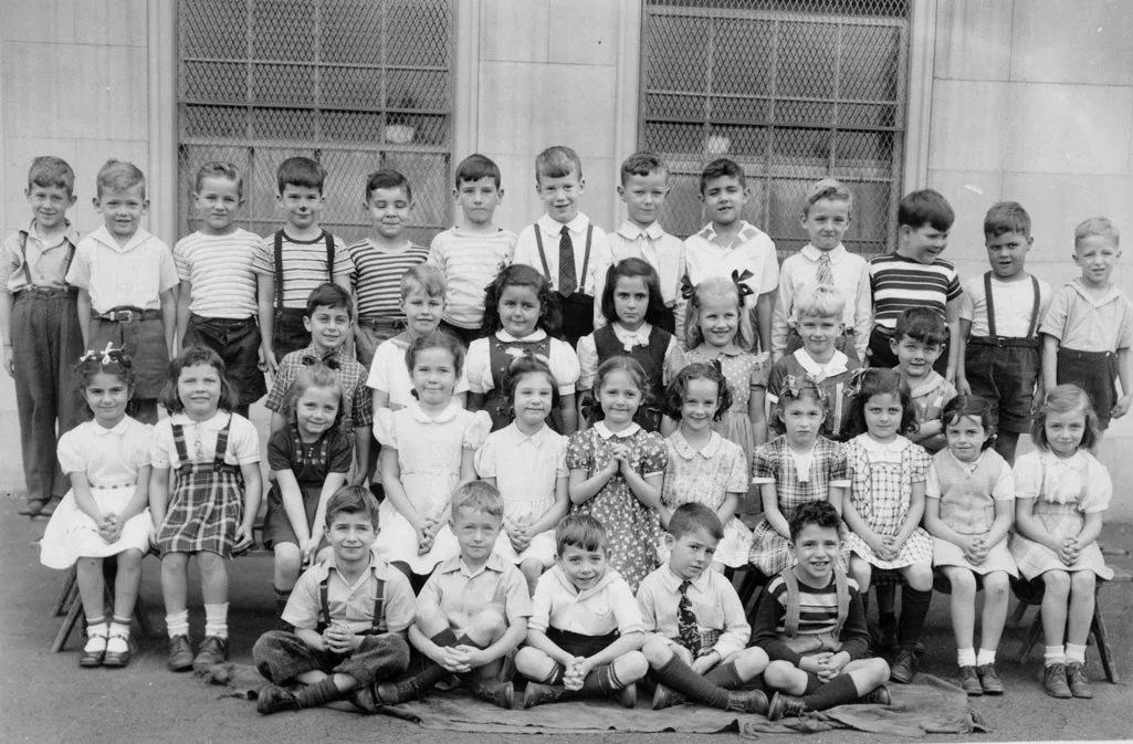 First grade class of Miss Edwina Barry at the Mary E. Curley Primary School in 1945. Photograph provided courtesy of Paul B. Gill, Jr. A high-resolution file of this photo can be downloaded here .