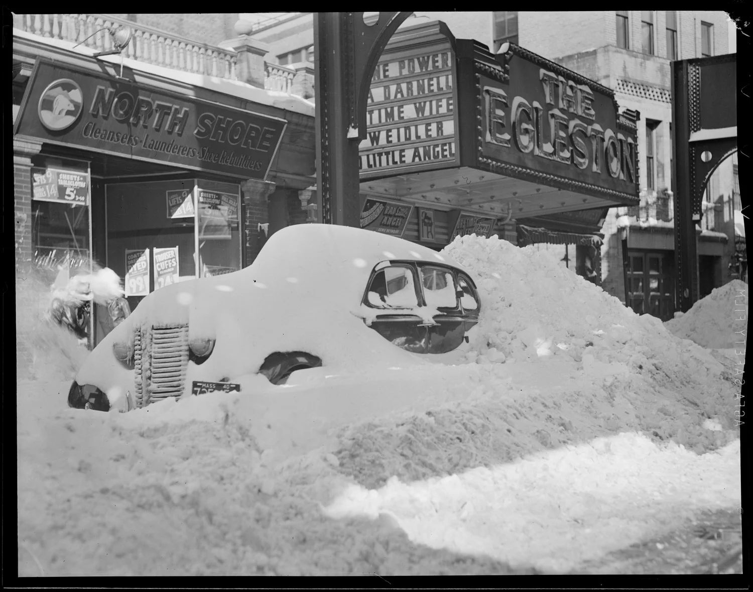 Car in snow in Egleston Square, circa 1939. Boston Public Library. https://www.flickr.com/photos/boston_public_library/8291463656/in/photolist-dCFVgW