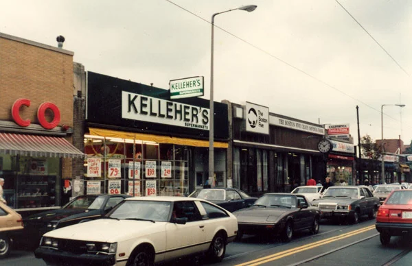 Woolworth's, 678 Centre St., Kelleher's Supermarket, 684 Centre St., Boston 5 Cents Savings Bank, 696 Centre St., and Yumont Tru-Value store, 702 Centre St.