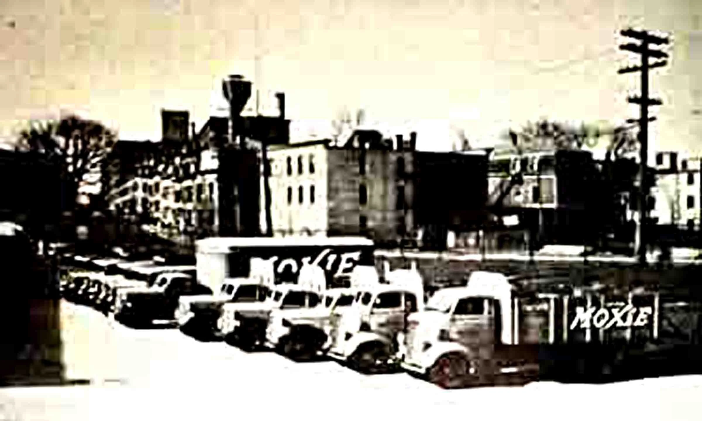 1950s image of delivery trucks parked outside Moxieland in Jamaica Plain.