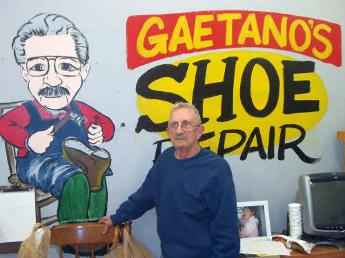 Guy Perito stands in front of a sign in his shop at Building #19