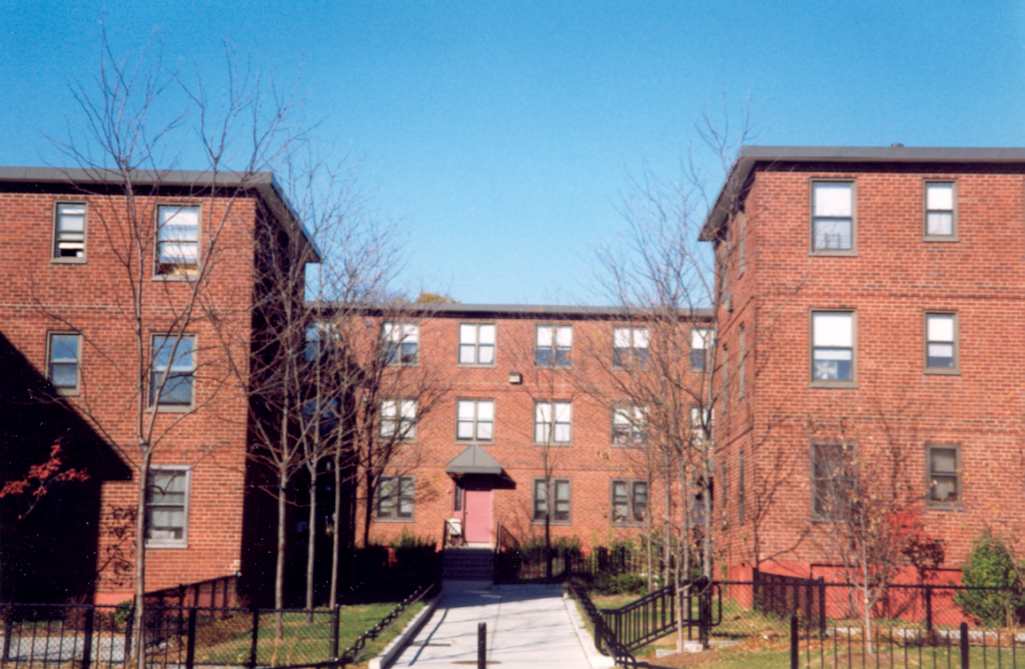 Heath Street houses showing the original flat roofs and courtyard formed by two apartment buildings. The new trees and lawn fencing are part of the 1996-1997 improvements.