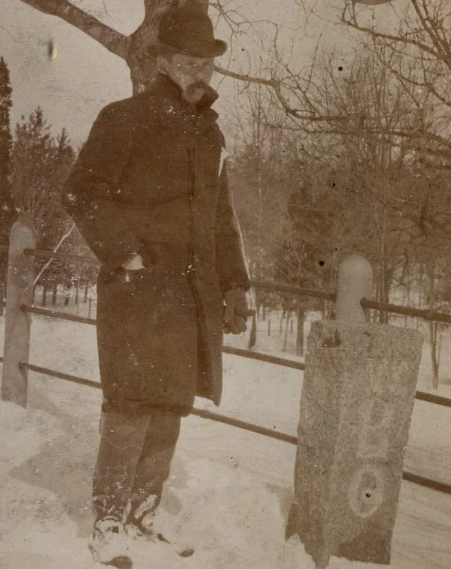 Man standing by boundry marker. Photograph provided courtesy of City of Boston Archives