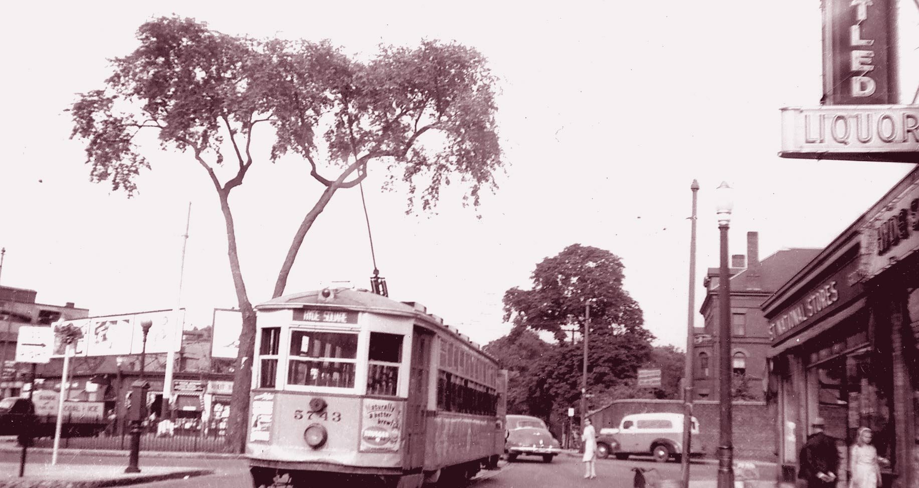  A trolley heads down Centre Street towards Jackson Square in this view of Hyde Square circa 1940.  Download photo . 