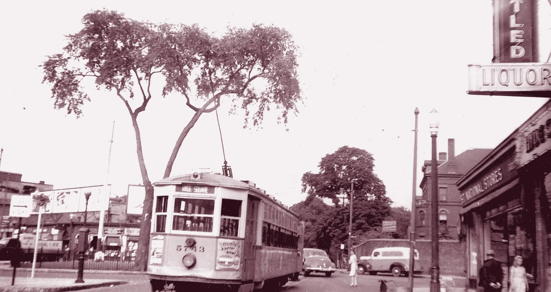 A trolley heads down Centre Street towards Jackson Square in this view of Hyde Square circa 1940. Download photo .