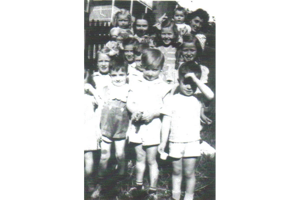 Backyard party Montebello Road 1940. First row left to right, Helen Cradock, Pauly Connaughton, Bobby Power, and Billy Connaughton. Second row, left to right, Mary Cradock, Joan Power, and Patsy Cradock. Back row, left to right, Catherine Coffey holding Chris Cradock and Marie Power holding baby.