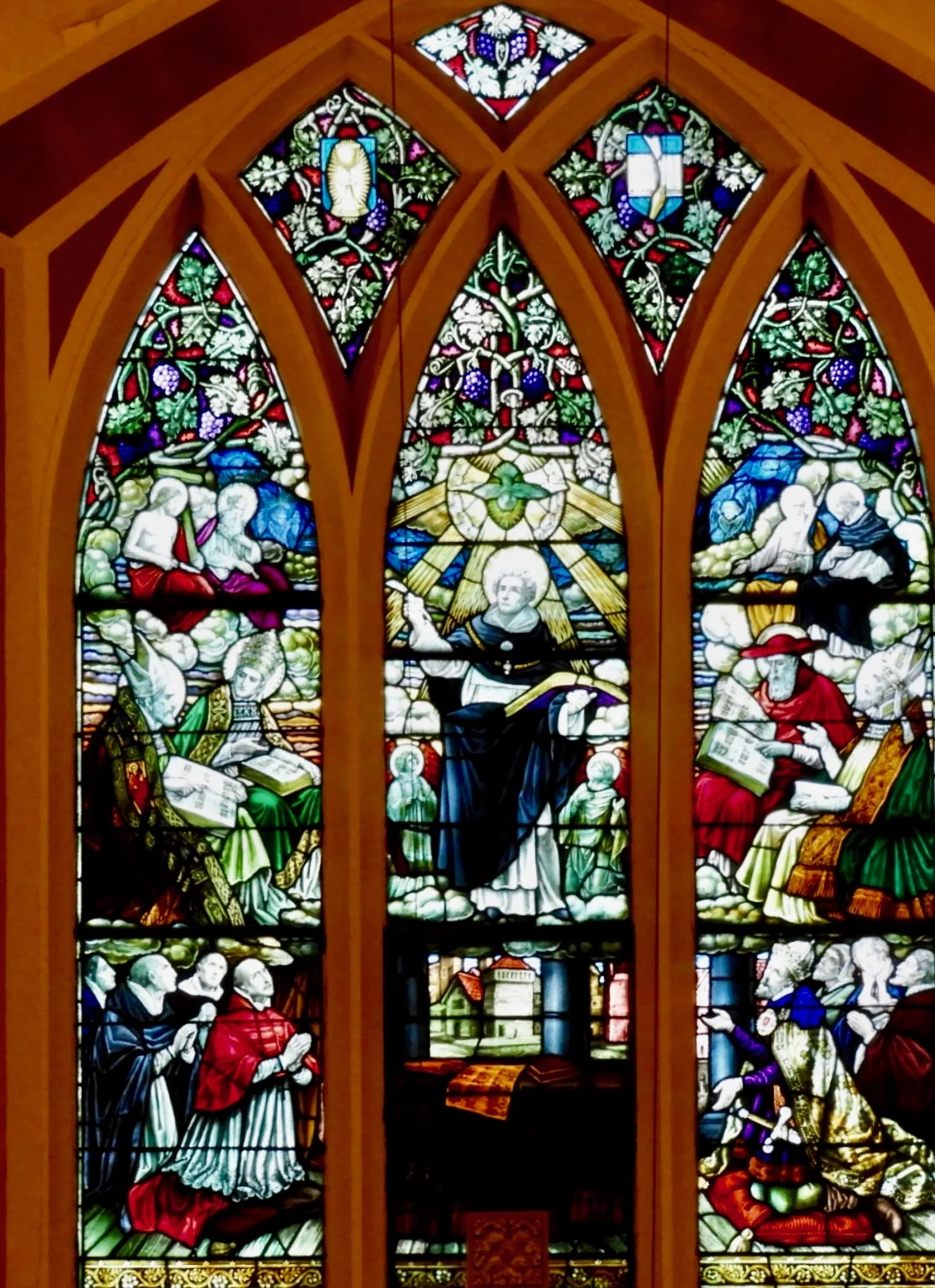 Stained glass window of St Thomas Aquinas teaching (situated over the reredos). Dates to 1873. Photograph by Richard Heath, 2019