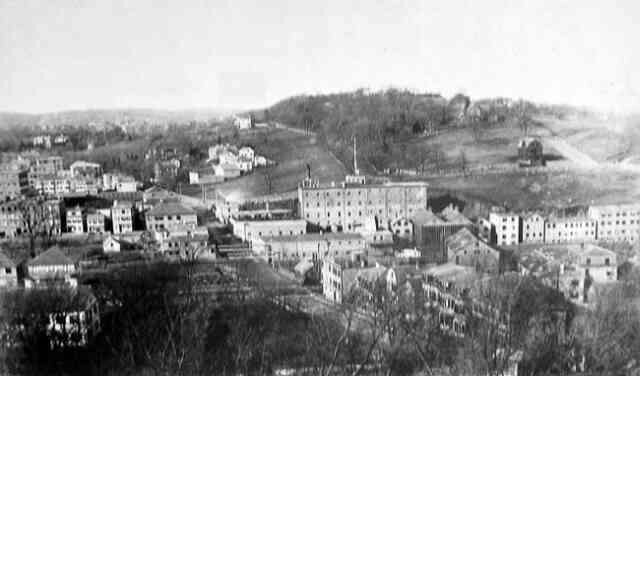  In this view of breweries and factories along the Stony Brook Valley, a portion of Mission Hill can be seen in the background. Courtesy of the Boston Public Library. 