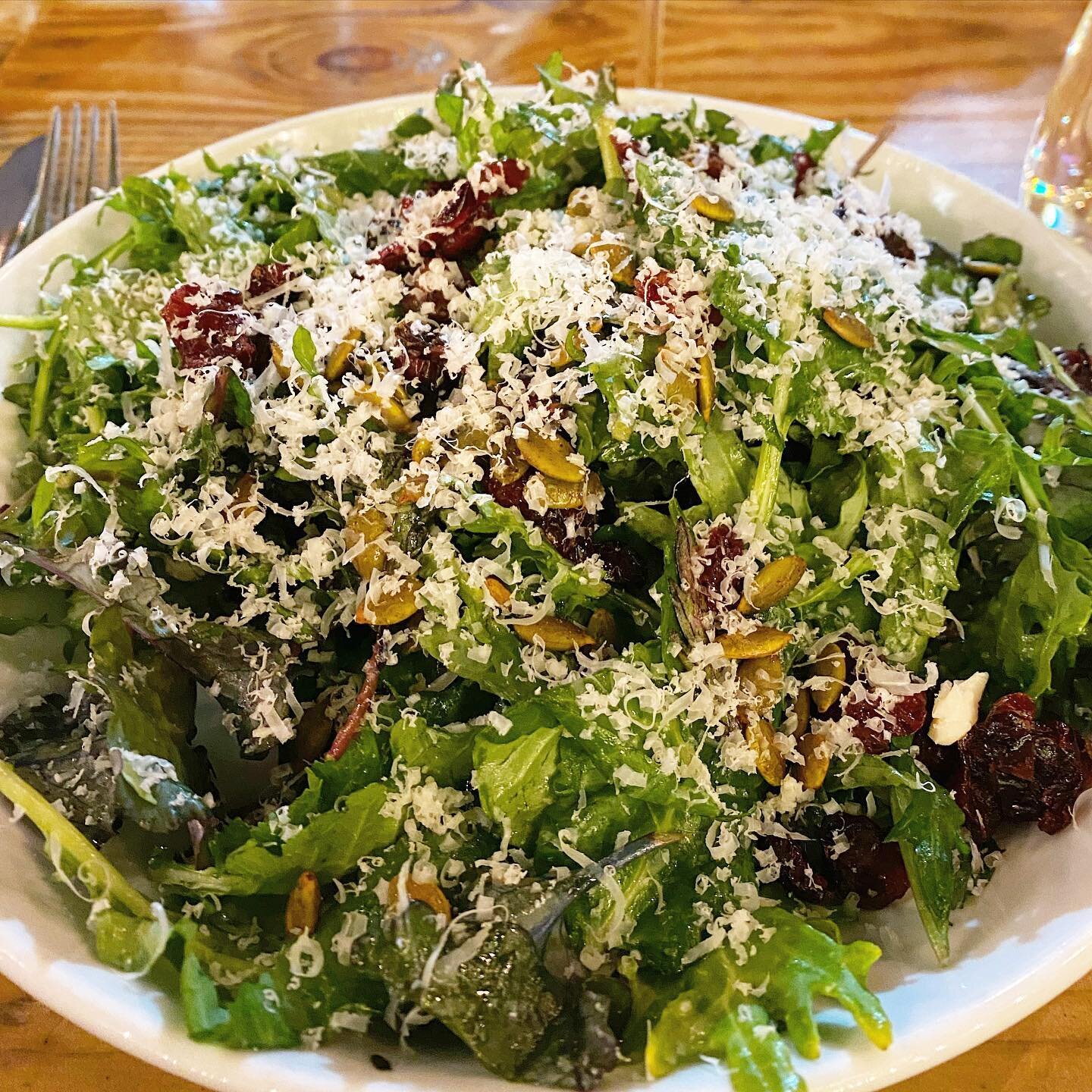 Baby Kale Salad made with baby kale, spiced pumpkin seeds, midnight moon cheese, dried cranberries &amp; apple vinaigrette 🙌. Available for patio dine in, curbside pick up &amp; free delivery!