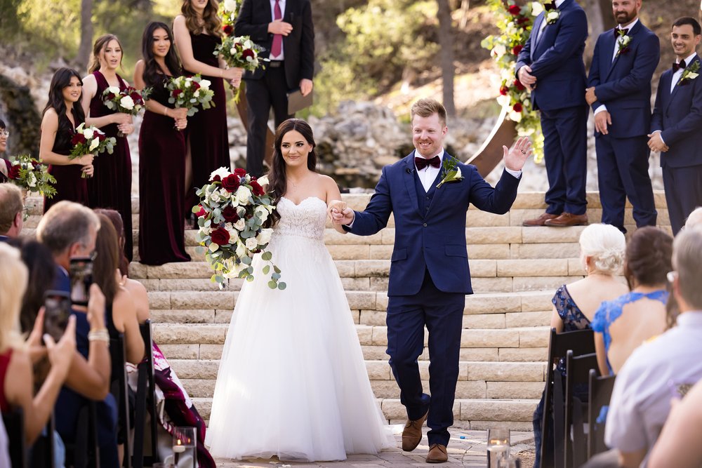 Bride Brittany and groom Aron walking down the aisle