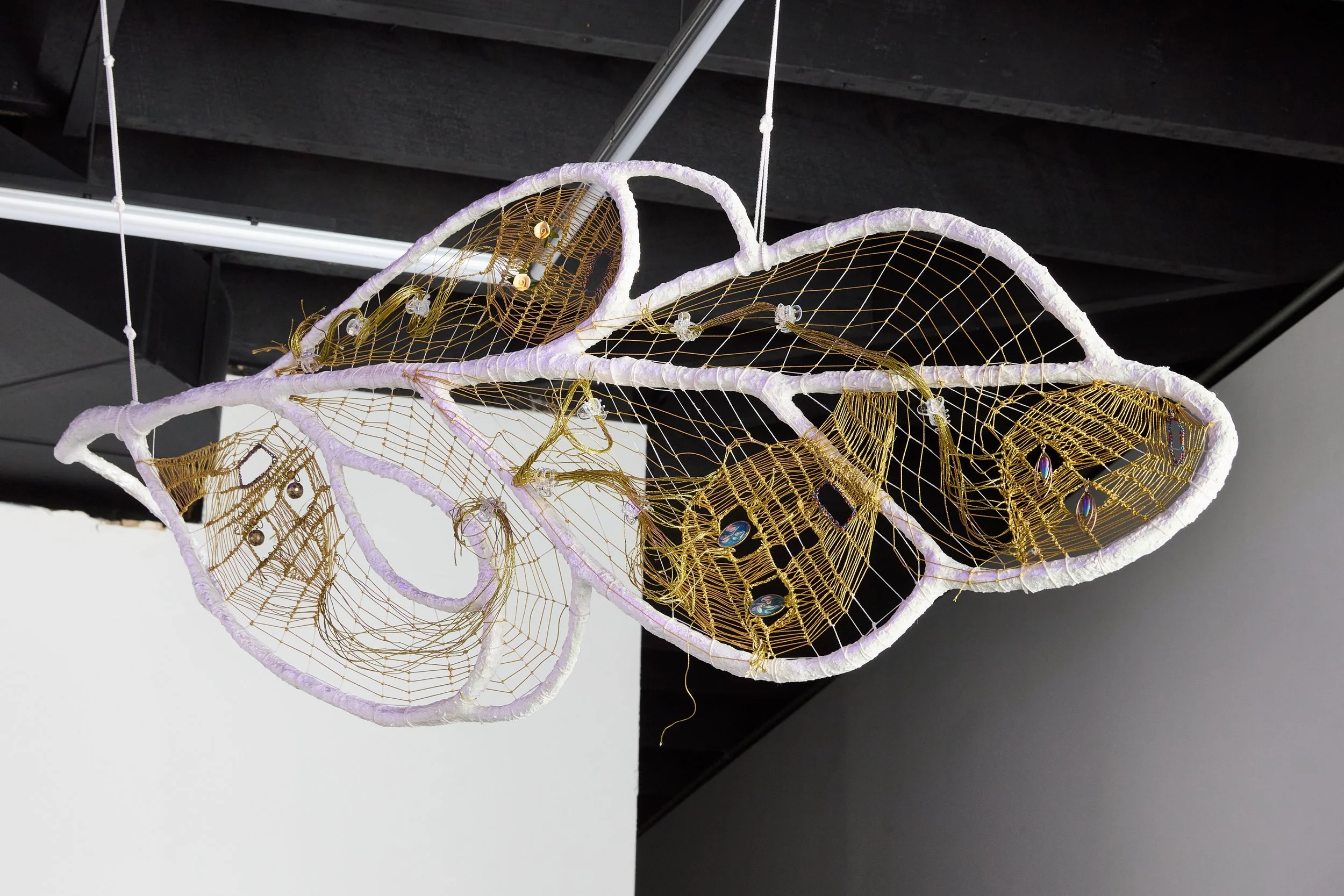   Leaf , 2026 reeds, earrings, branches, wire, resin, crystals, lamé cord, linen cord, rope, chain, plastic flowers 46 x 20 x 6 in. (117 × 51 x 15 cm) 
