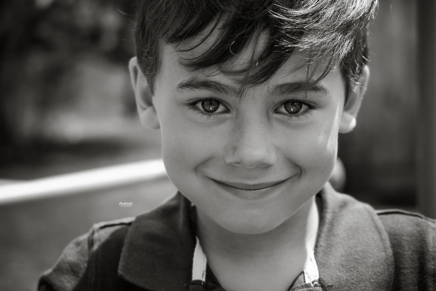 Little boy looking directly into the camera smiling close up black and white Family photography Kitchener-Waterloo