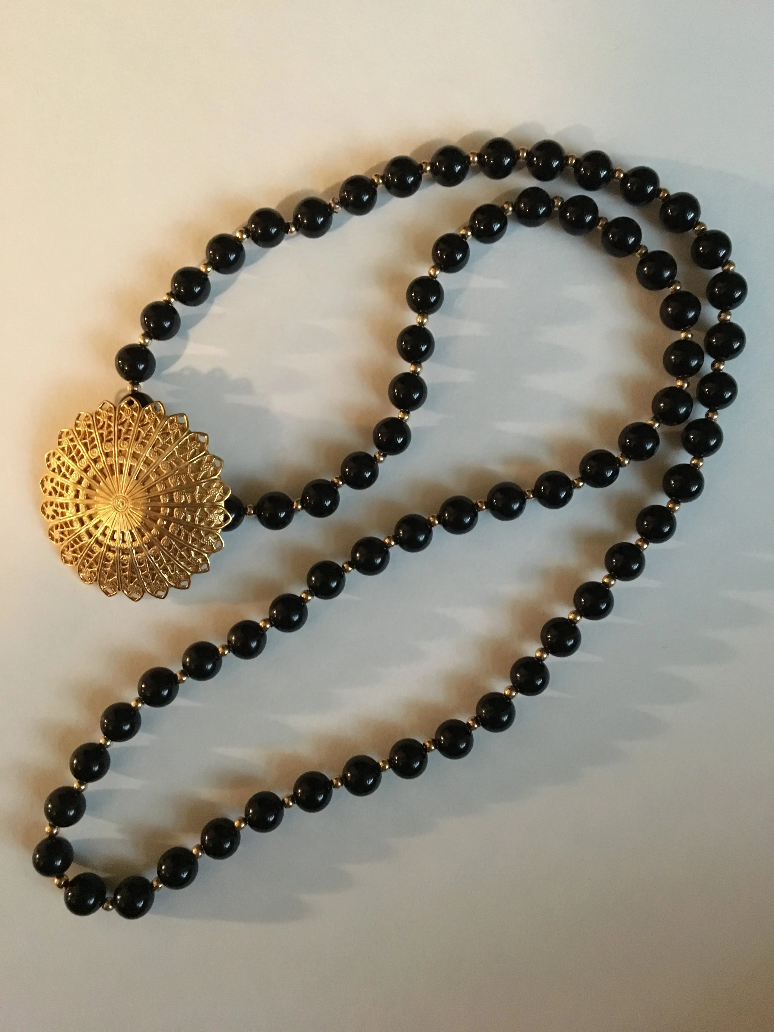 Gold medallion on black glass bead necklace