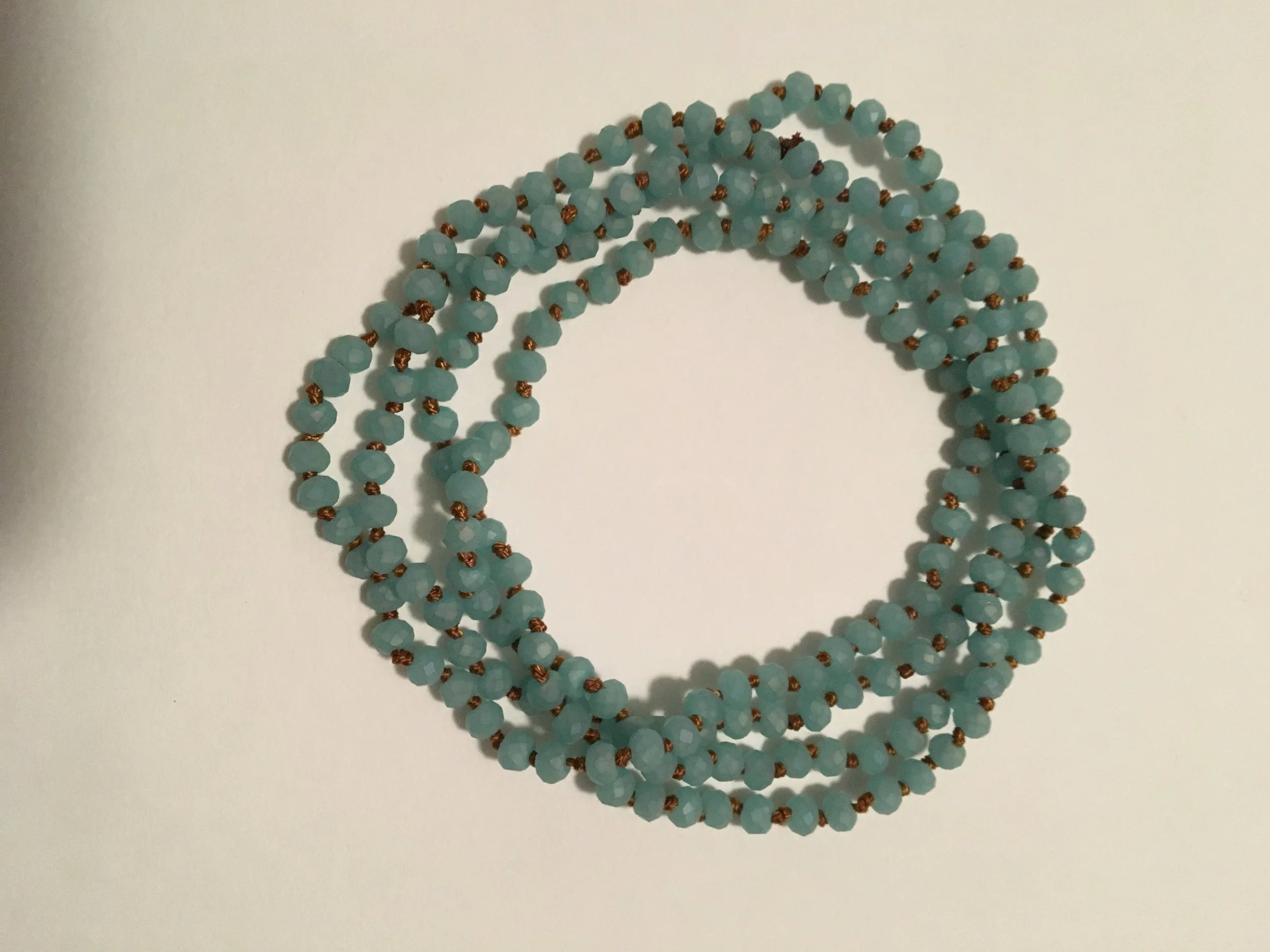 Wrap bracelet knotted w/small teal wooden beads