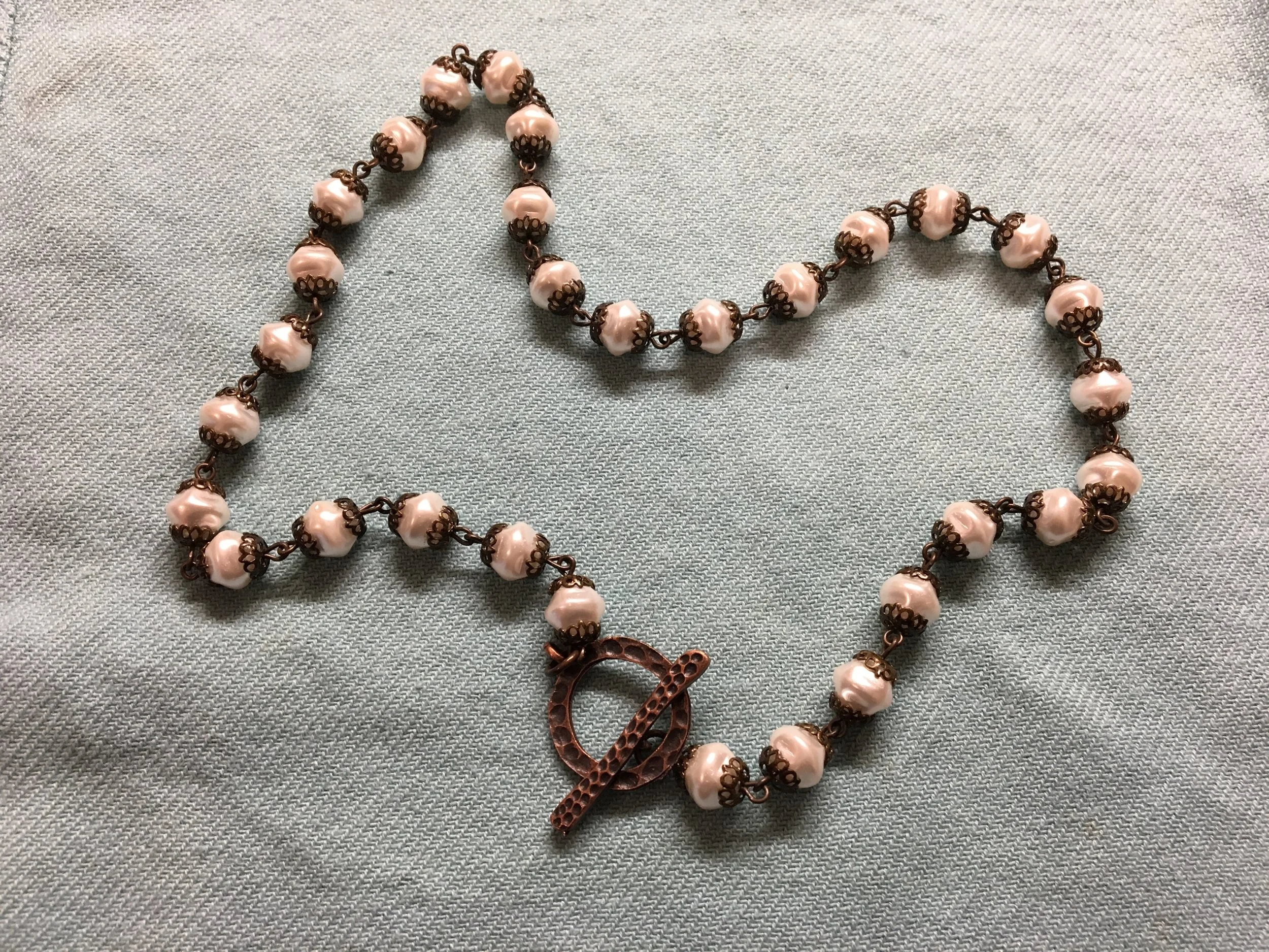 Round pearl necklace with bronze filigree and choice of clasp