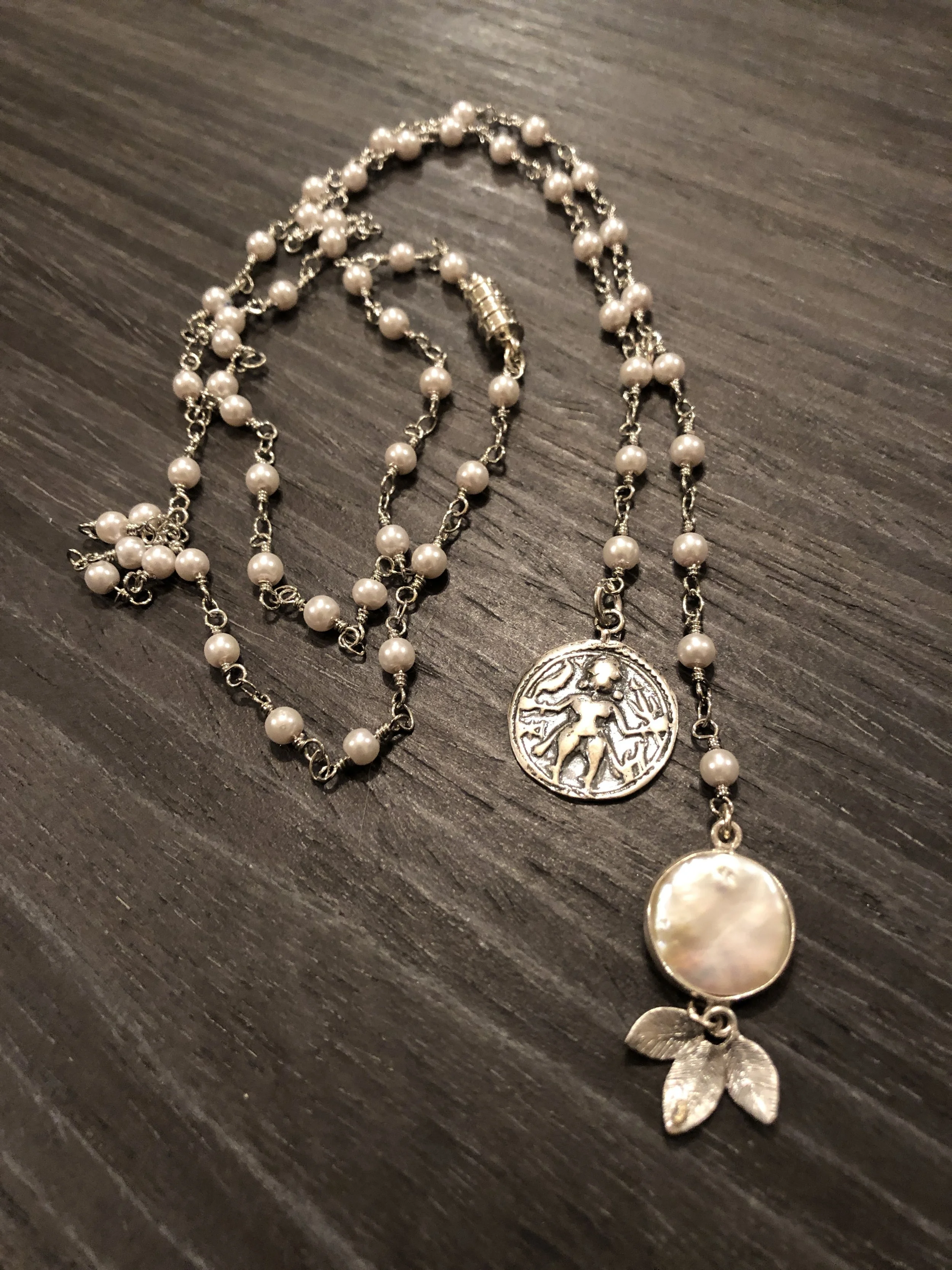 Silver coin, and coin pearl, on silver wrapped pearls...