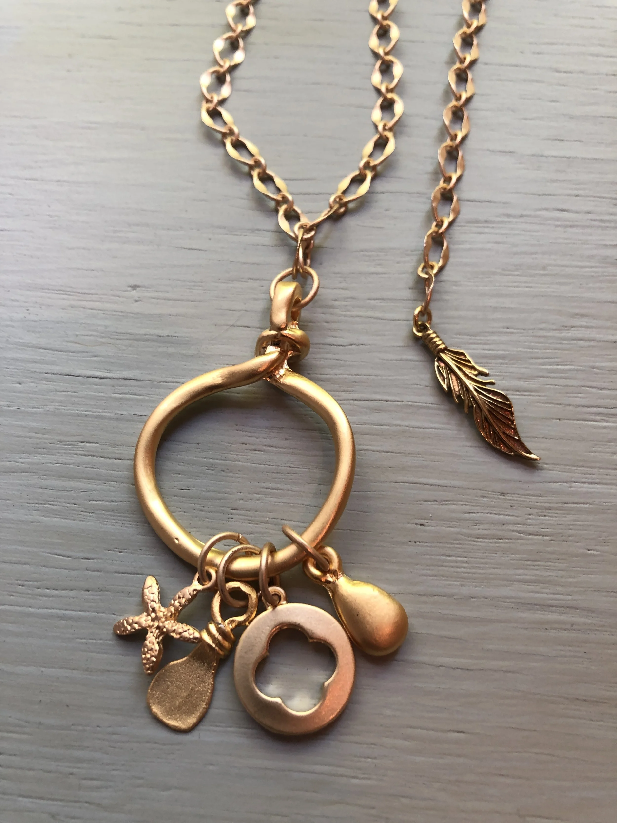 Matte gold loop and charm necklace