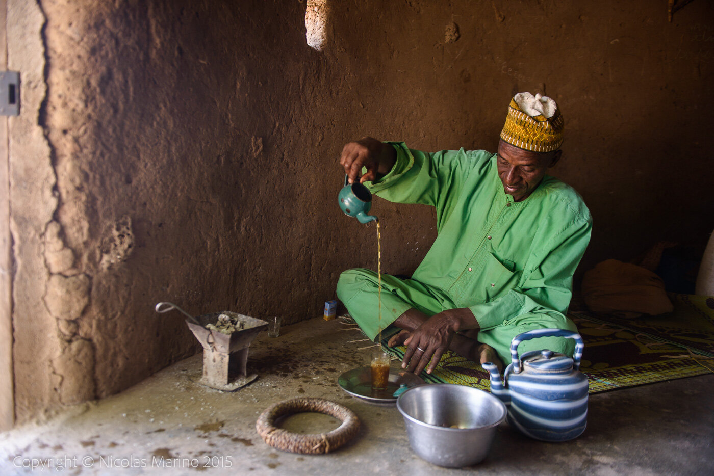 A Fulani man preparing tea, in a village of the Sahel. Burkina Faso