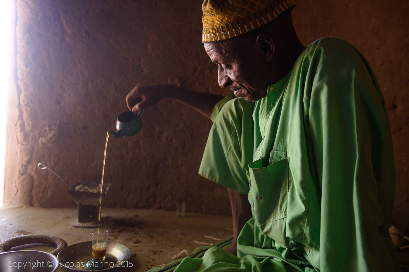 A Fulani man preparing tea, in a village of the Sahel. Burkina Faso