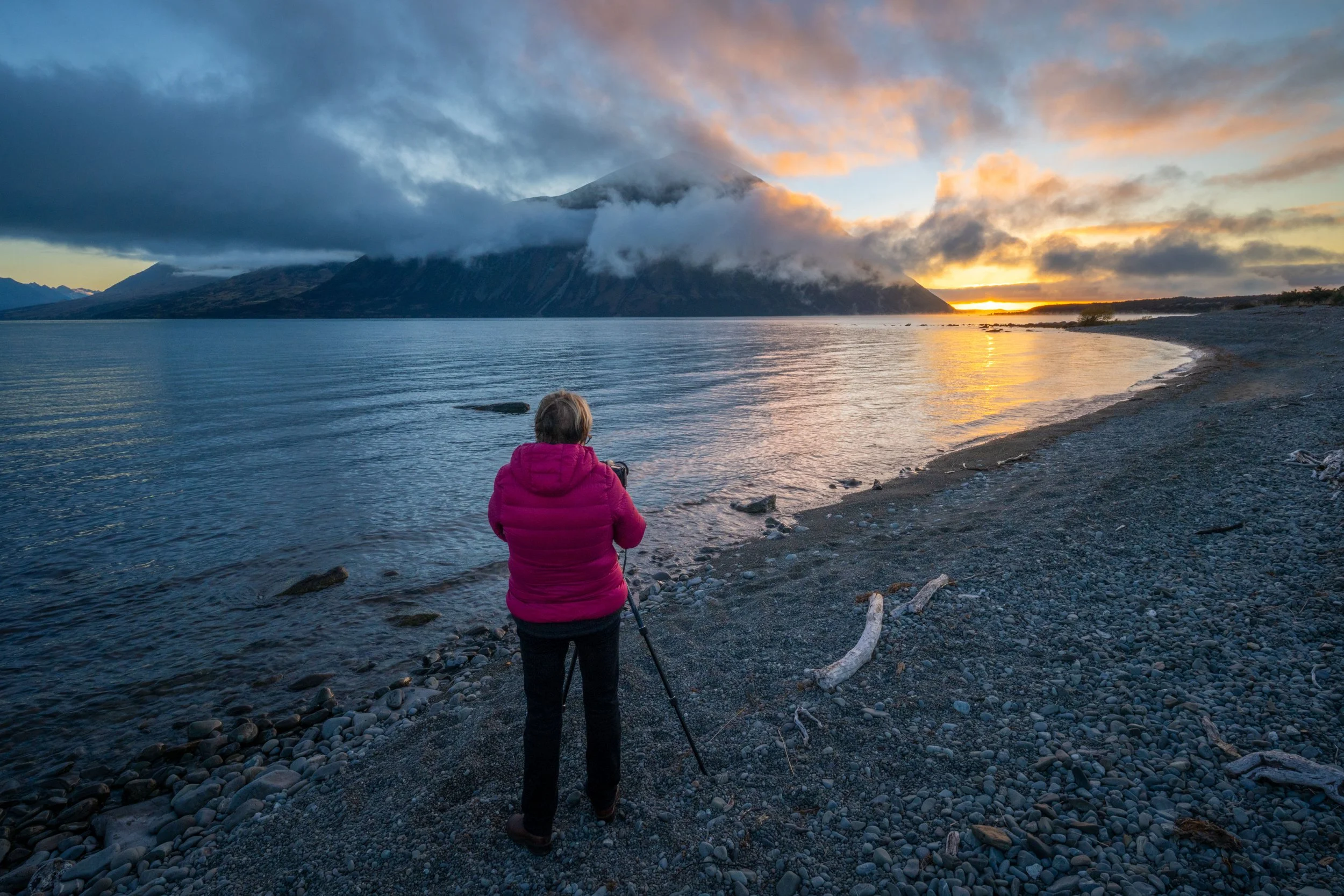Photography workshop participant photographing a mountain beside a lake