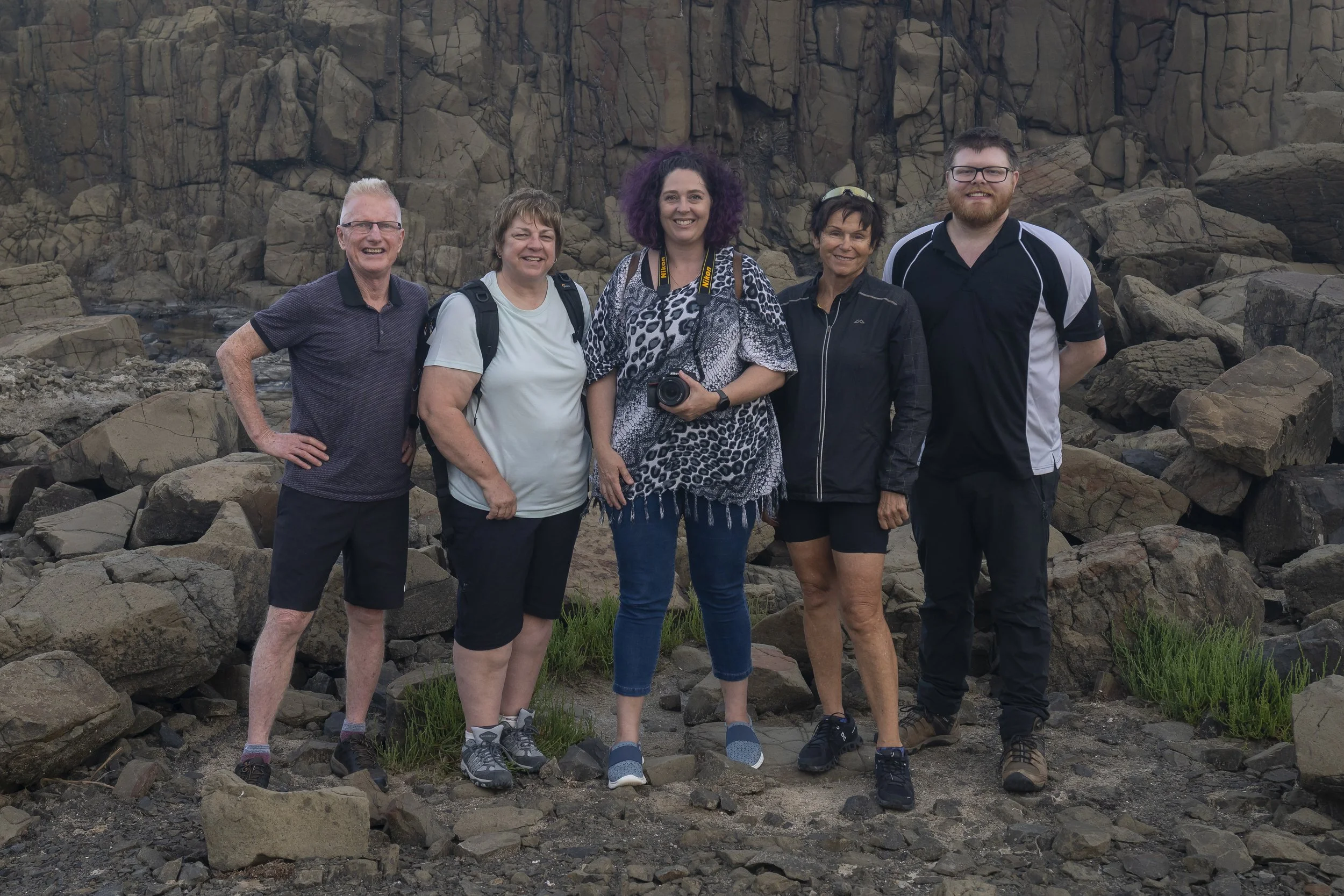 Photography workshop participants posing together after an outdoor session