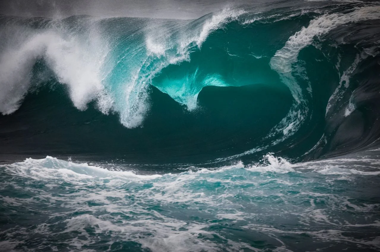 Large breaking wave with white foam and spray