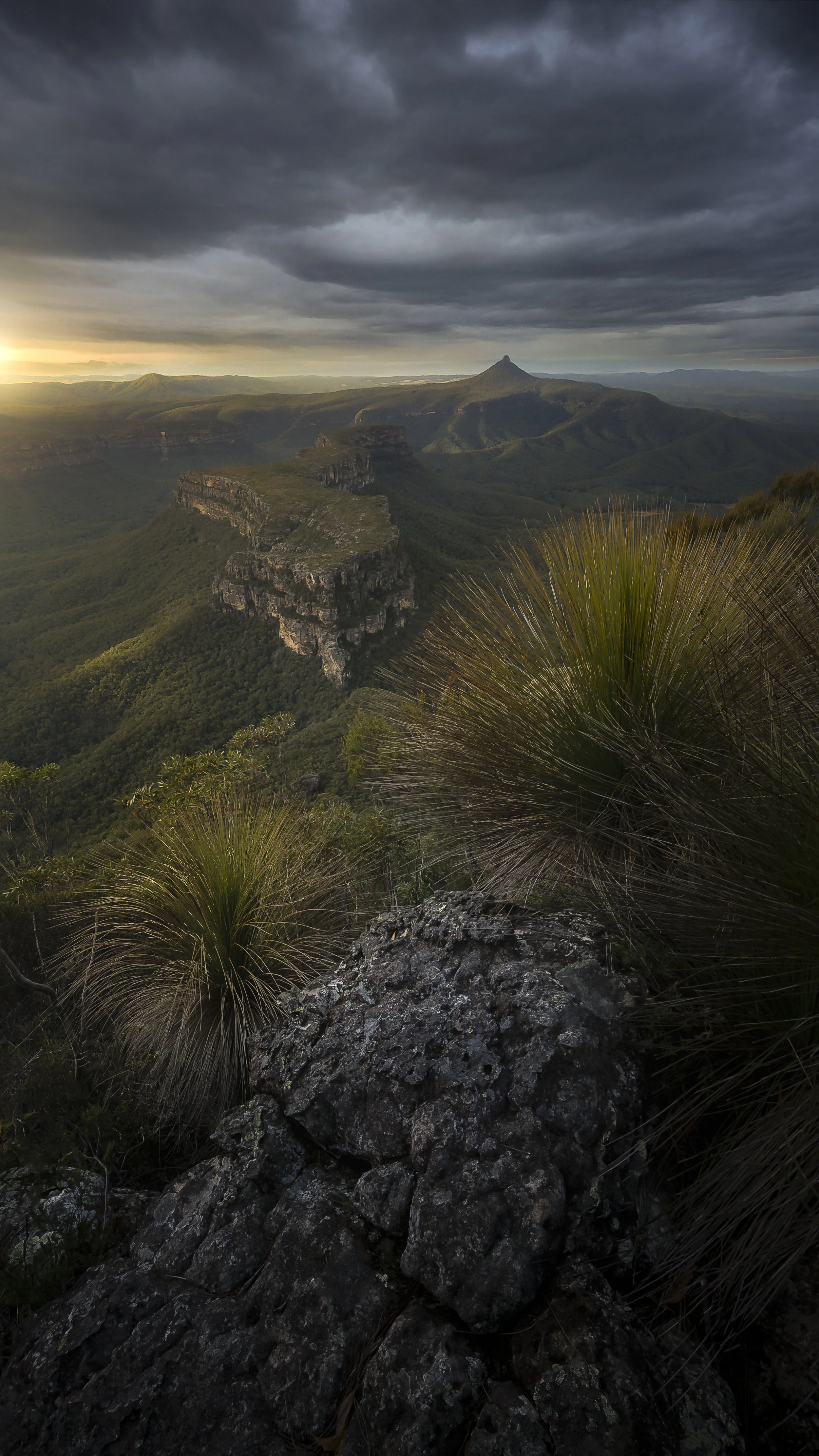 Early morning light over The Castle in the Budawangs, Australia, highlighting rocky cliffs and valleys during sunrise