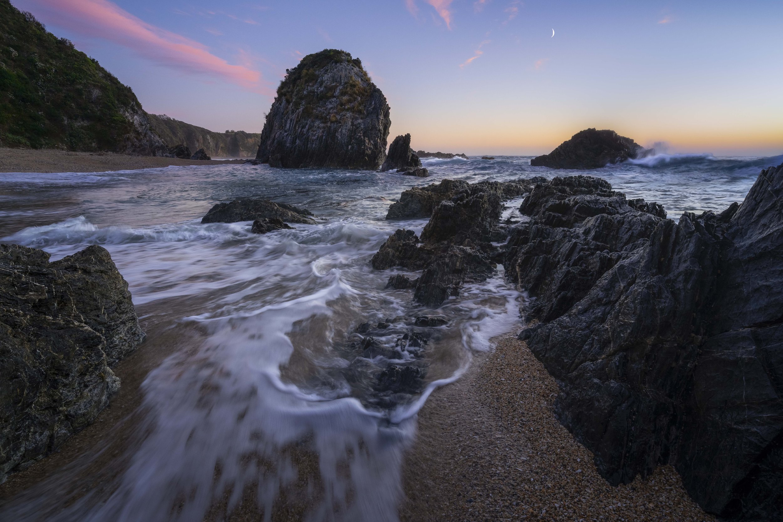 Sunrise over a sea stack along the coastline