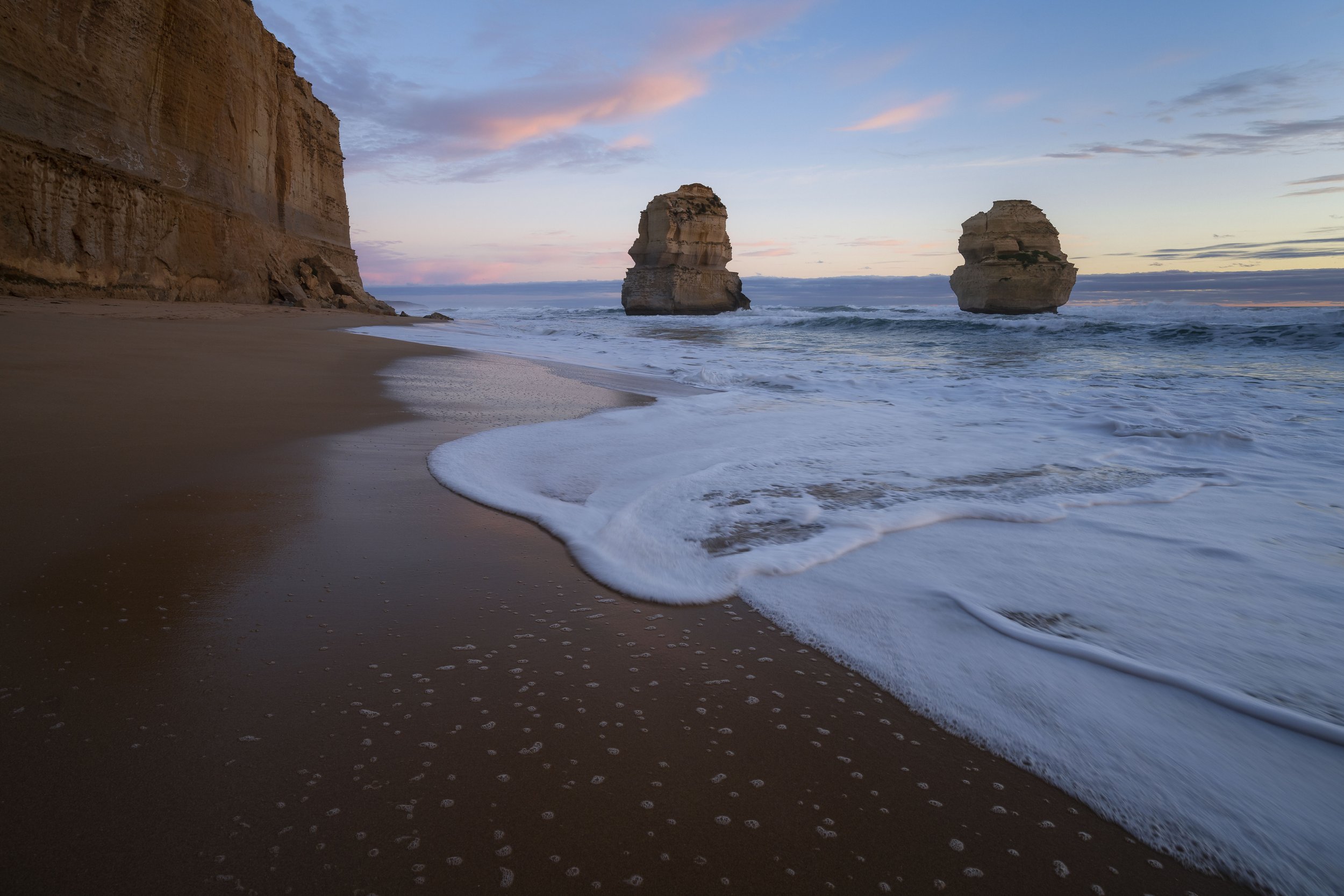 Sunset over the ocean and cliffs at Gibson Steps