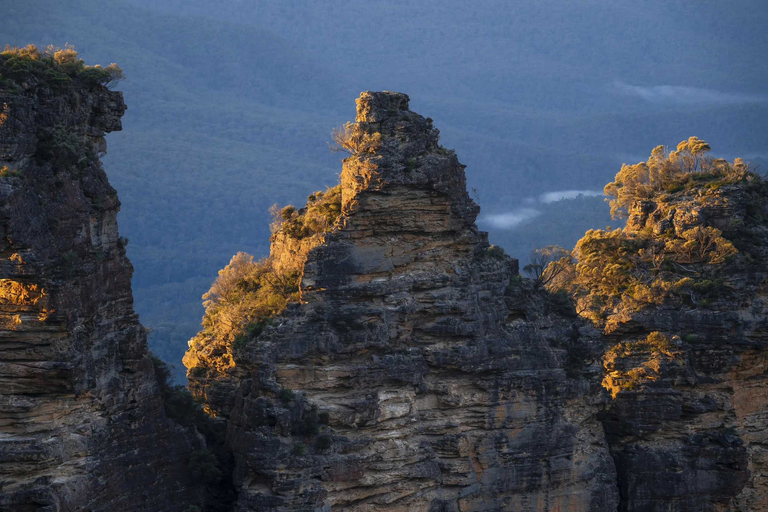 Morning light shining on the Three Sisters rock formation in the Blue Mountains, Australia